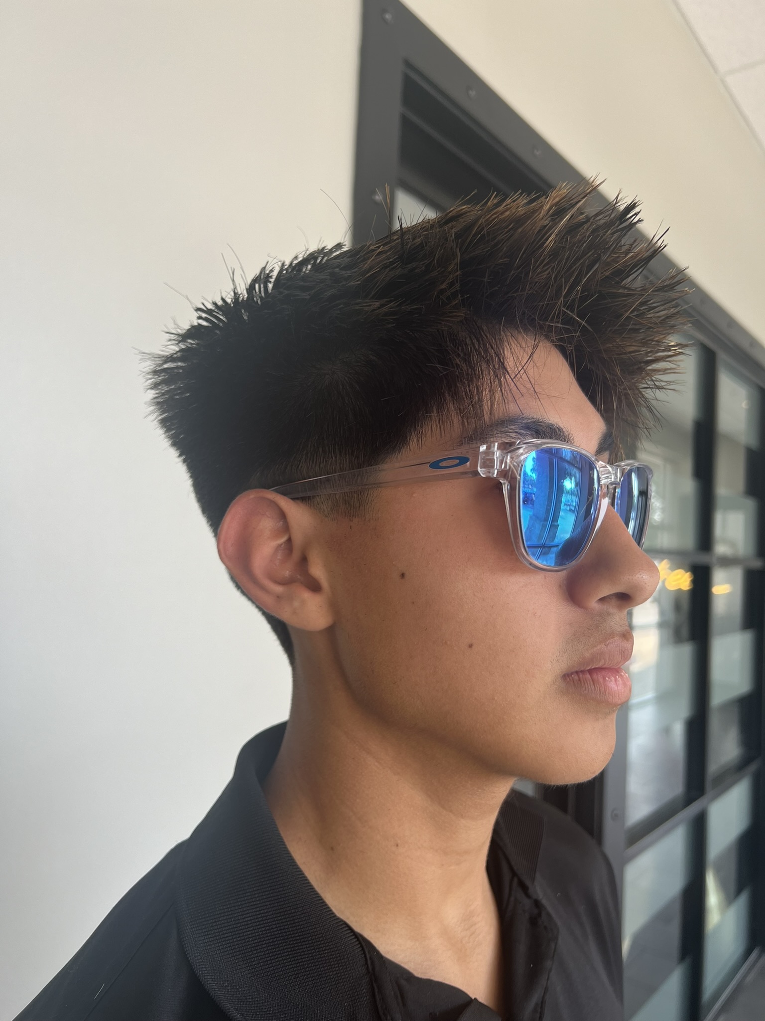 Teen at an angle wearing sunglasses showing new haircut from Beard and Beauty's in Cedar Park, Texas